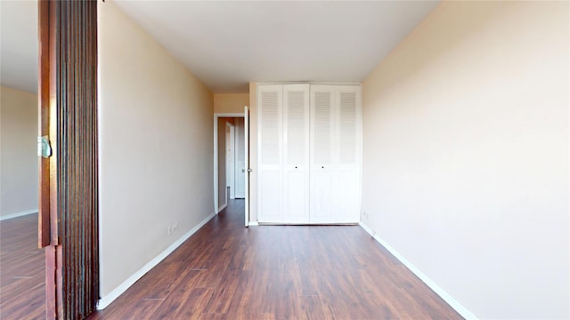 66-36 Yellowstone Blvd Unit 21C, Forest Hills, NY 11375 - unfurnished bedroom featuring baseboards, a closet, and dark wood-type flooring