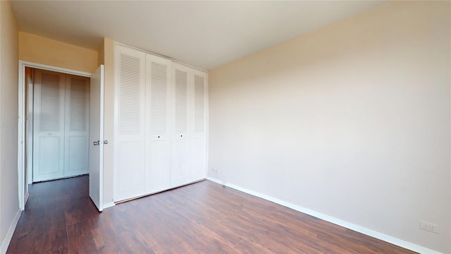 66-36 Yellowstone Blvd Unit 21C, Forest Hills, NY 11375 - unfurnished bedroom with baseboards, a closet, and dark wood-style flooring