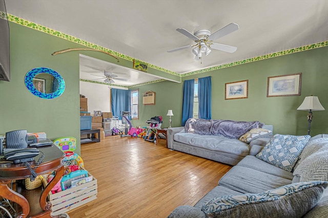 living room featuring wood-type flooring and ceiling fan