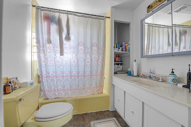 bathroom with stone finish flooring, visible vents, shower / tub combo, vanity, and toilet