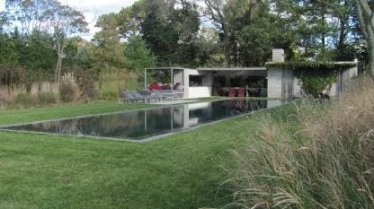 rear view of house featuring a yard