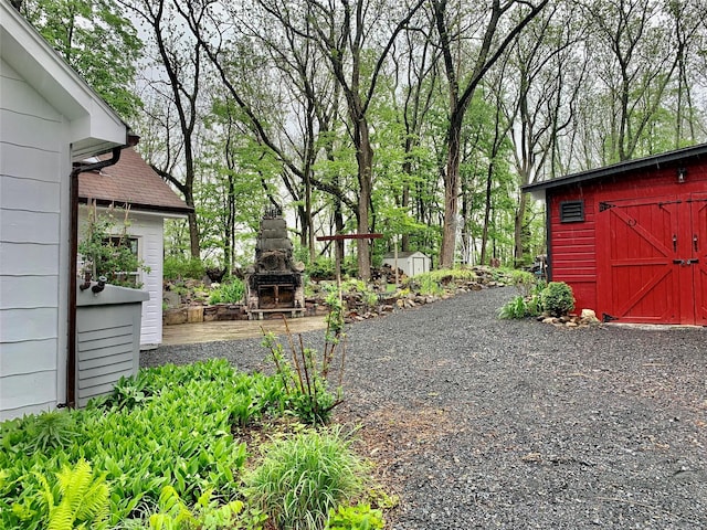 781 Pine Island Tpke, Warwick, NY 10990 - view of yard featuring a storage shed, an outdoor structure, and an outdoor stone fireplace