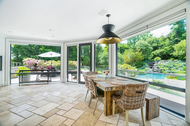 sunroom / solarium with a water view and a wealth of natural light