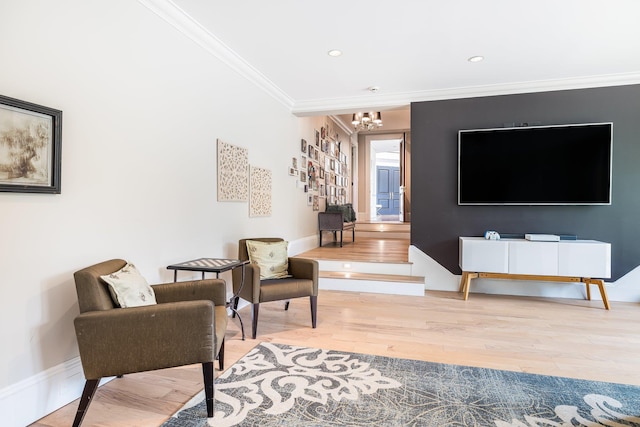 sitting room featuring wood finished floors, recessed lighting, crown molding, a chandelier, and baseboards