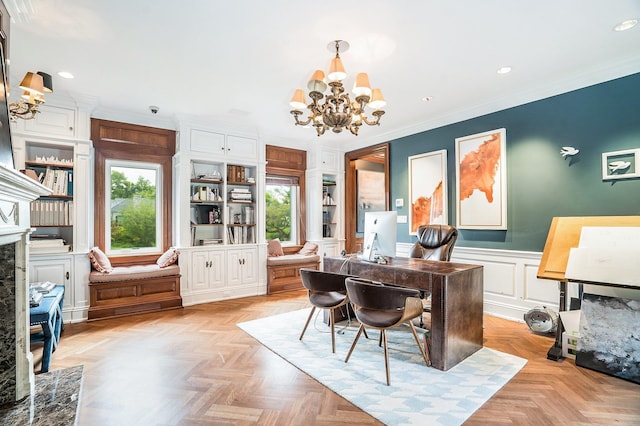 home office featuring an inviting chandelier, a wealth of natural light, a wainscoted wall, and crown molding