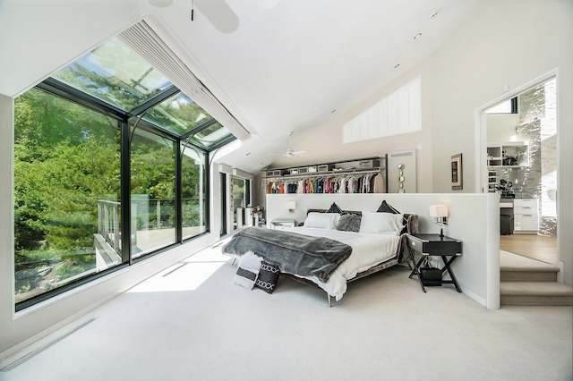 carpeted bedroom featuring lofted ceiling, multiple windows, and ceiling fan