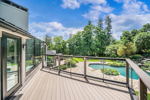 wooden deck featuring an outdoor pool