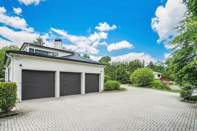 garage with decorative driveway