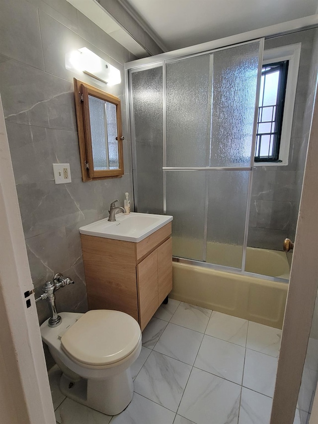 1503 Metropolitan Ave Unit 2F, Bronx, NY 10462 - bathroom with tile walls, combined bath / shower with glass door, vanity, and toilet