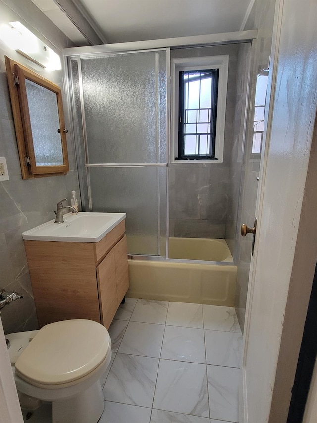 1503 Metropolitan Ave Unit 2F, Bronx, NY 10462 - bathroom featuring marble finish floor, toilet, vanity, and shower / bath combination with glass door