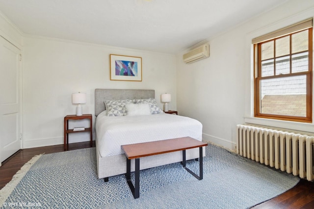 bedroom featuring an AC wall unit, ornamental molding, radiator heating unit, and wood finished floors