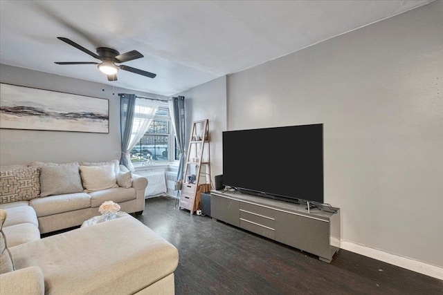 living room featuring baseboards, a ceiling fan, and dark wood-style floors
