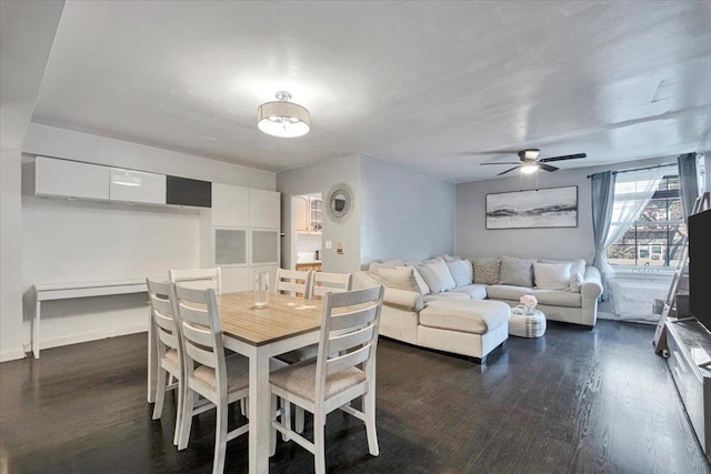 dining area with dark wood-style flooring and ceiling fan