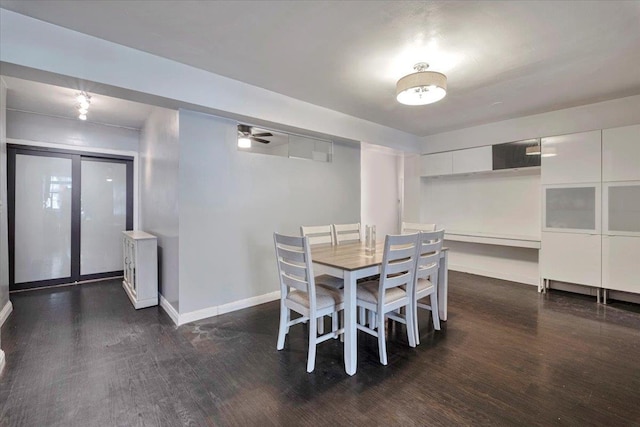 dining space featuring baseboards, ceiling fan, and wood finished floors