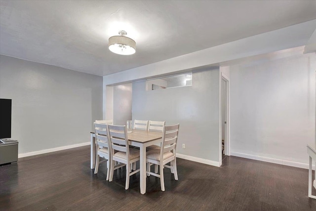 dining room with baseboards and wood finished floors