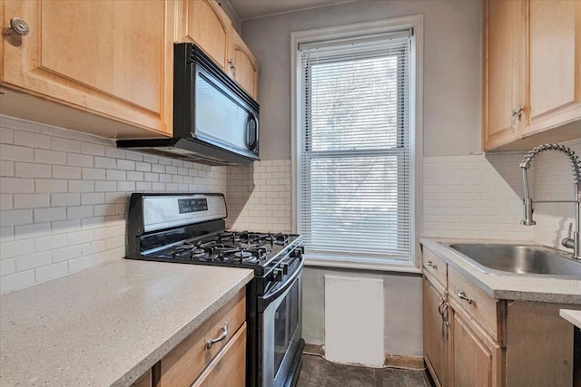 kitchen with a sink, light brown cabinetry, gas stove, and light countertops