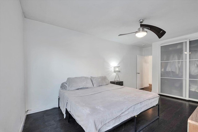 bedroom featuring baseboards, a ceiling fan, and wood finished floors