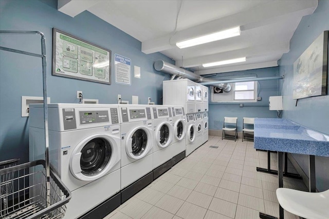 common laundry area with tile patterned flooring, stacked washing maching and dryer, and washing machine and dryer
