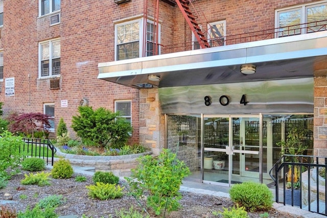 entrance to property featuring brick siding