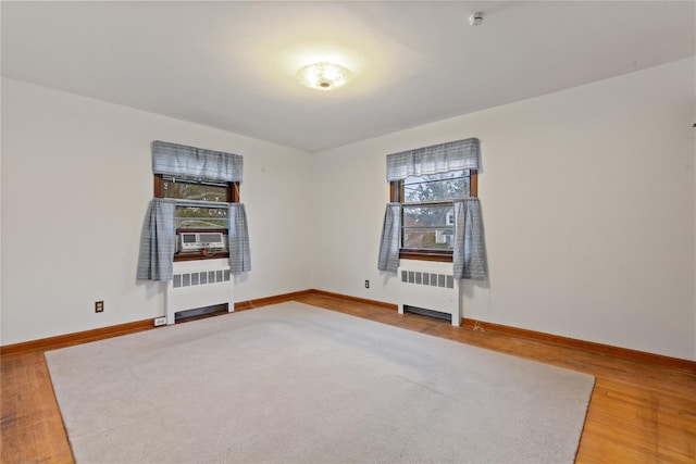 12 Brundage St, Armonk, NY 10504 - empty room with radiator, plenty of natural light, and baseboards