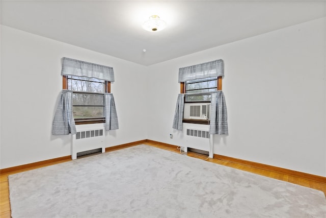 12 Brundage St, Armonk, NY 10504 - empty room featuring baseboards, radiator heating unit, and wood finished floors