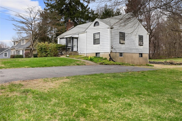 12 Brundage St, Armonk, NY 10504 - view of side of home featuring a lawn, cooling unit, and a chimney
