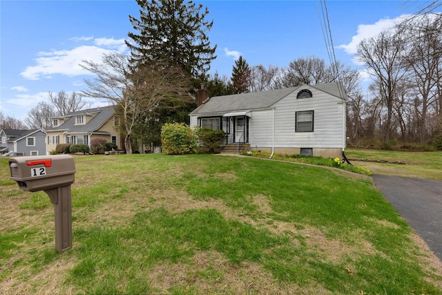 12 Brundage St, Armonk, NY 10504 - view of front of house featuring a chimney and a front yard