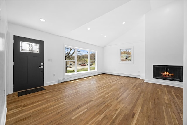 338 Rte 211 W, Middletown, NY 10940 - unfurnished living room with recessed lighting, high vaulted ceiling, a lit fireplace, baseboards, and wood finished floors
