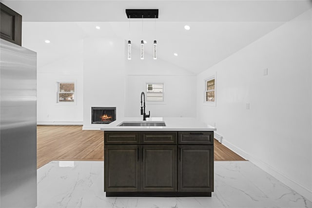 338 Rte 211 W, Middletown, NY 10940 - kitchen with a warm lit fireplace, stainless steel fridge, vaulted ceiling, marble finish floor, and a sink