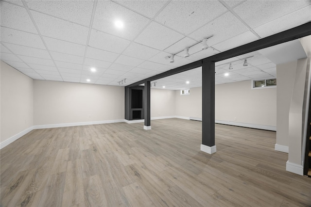 338 Rte 211 W, Middletown, NY 10940 - finished basement with baseboards, wood finished floors, a baseboard radiator, and a paneled ceiling