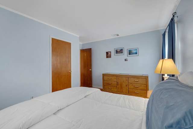 bedroom featuring visible vents and ornamental molding