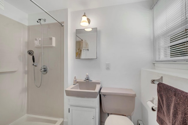 bathroom with vanity, walk in shower, and toilet