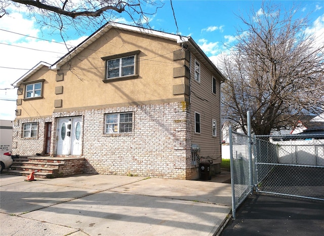 16739 147th Ave, Springfield Gardens, NY 11434 - exterior space featuring stucco siding and fence