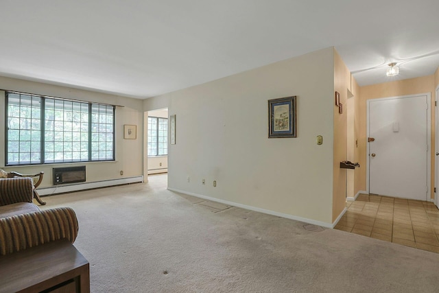 sitting room featuring baseboard heating, baseboards, a baseboard heating unit, and carpet flooring