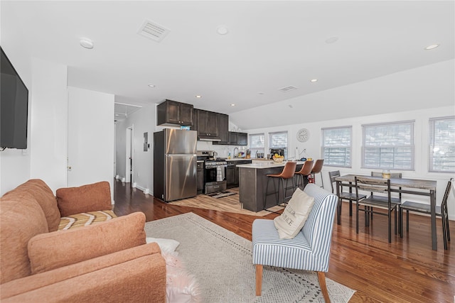 living area featuring recessed lighting, wood finished floors, and visible vents