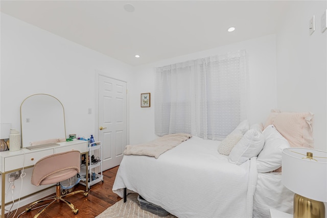 bedroom with recessed lighting and wood finished floors