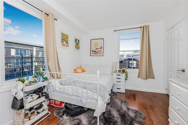 bedroom with baseboards and wood finished floors