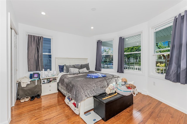 bedroom with recessed lighting and wood finished floors