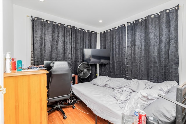 bedroom featuring recessed lighting and wood finished floors