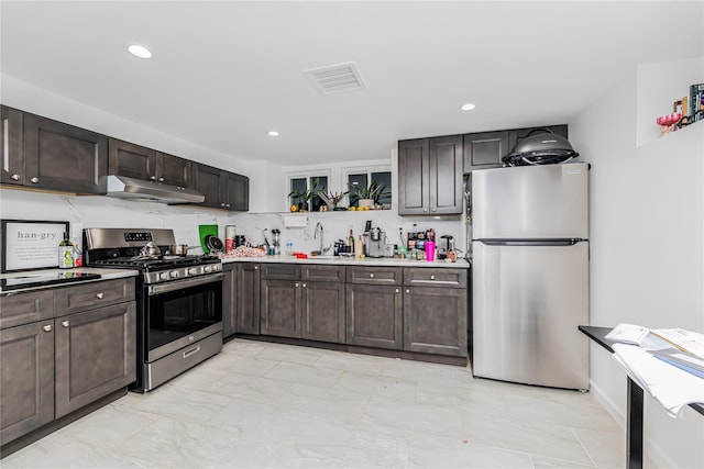 kitchen featuring appliances with stainless steel finishes, under cabinet range hood, dark brown cabinets, and visible vents