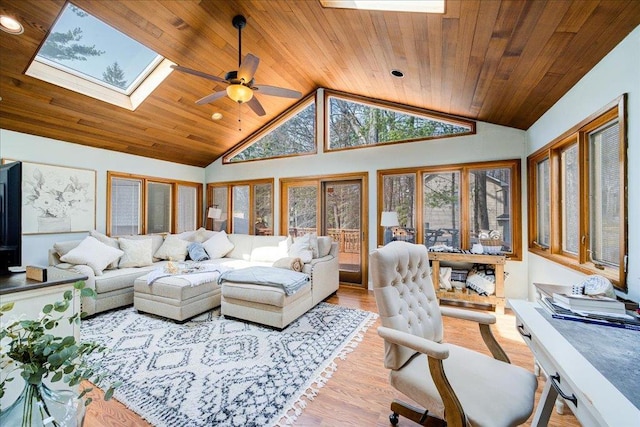 living area with vaulted ceiling with skylight, light wood-style floors, ceiling fan, wooden ceiling, and recessed lighting