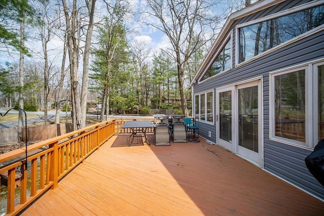 wooden terrace with fence and outdoor dining space