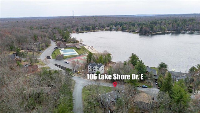 drone / aerial view featuring a view of trees and a water view