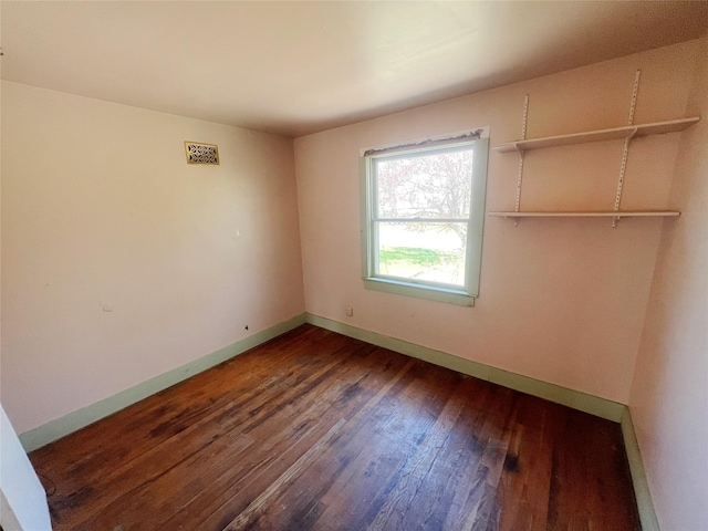 unfurnished bedroom with wood finished floors and baseboards