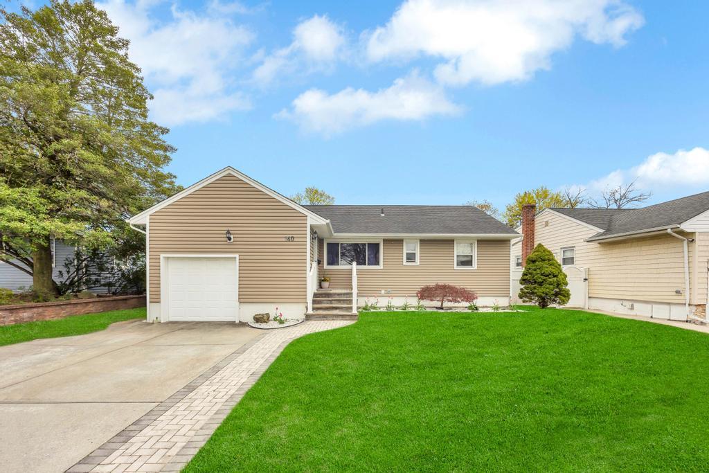 140 Saddle Rock Rd, Valley Stream, NY 11581 - ranch-style home with an attached garage, a front yard, and concrete driveway