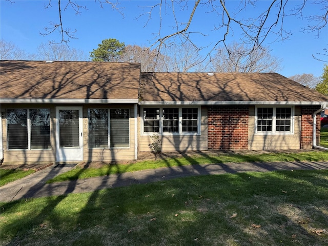 79 Enfield Ct Unit B, Ridge, NY 11961 - ranch-style house featuring brick siding, roof with shingles, and a front yard