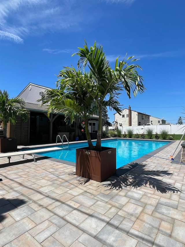 view of pool with a fenced in pool, a patio area, and fence