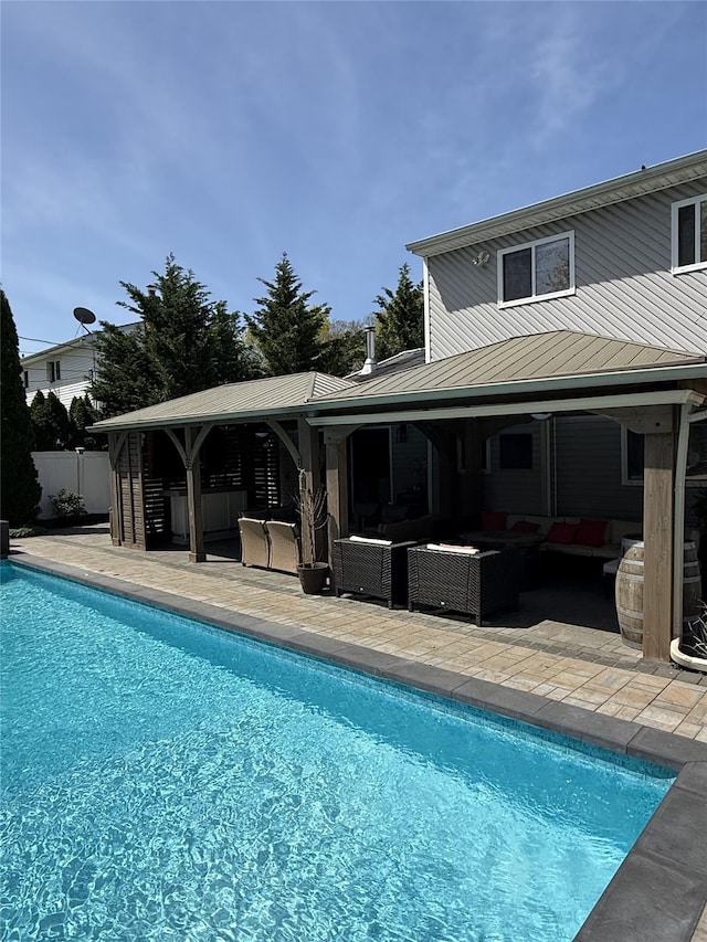 outdoor pool featuring fence, an outdoor living space, and a patio area