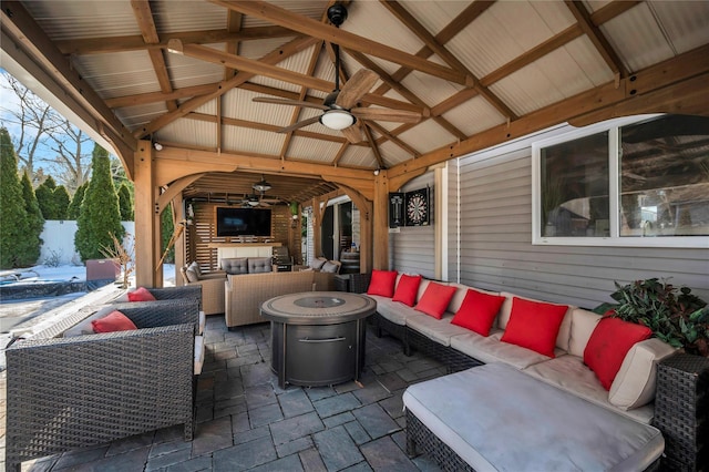 view of patio featuring a gazebo, an outdoor living space with a fire pit, and ceiling fan