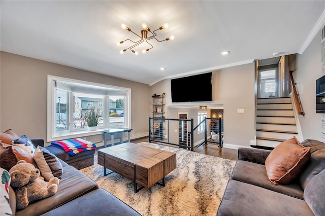 living area with crown molding, stairs, wood finished floors, baseboards, and recessed lighting